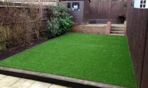 dirt garden with patches of grass - before